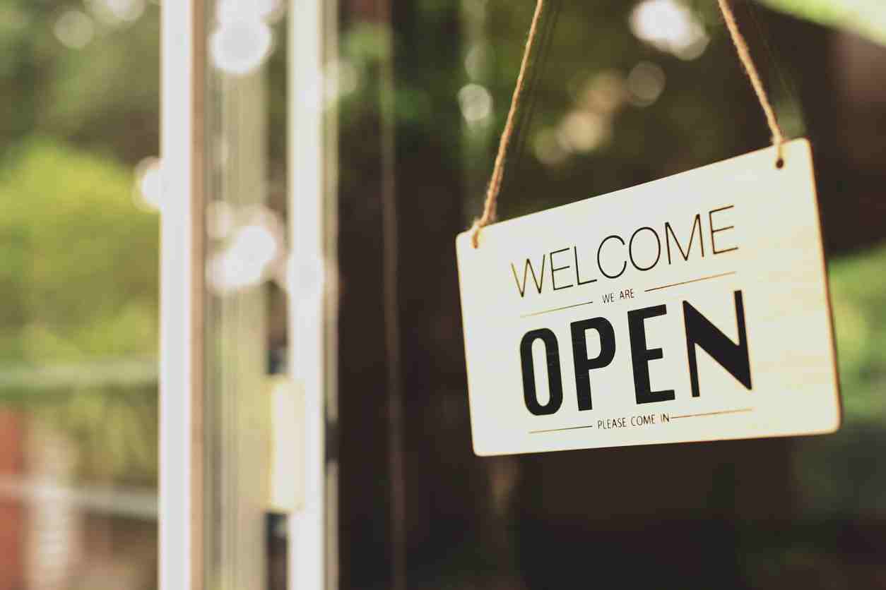 Stay ahead of the Slowdown Hero image. Picture of we're open sign on shopfront